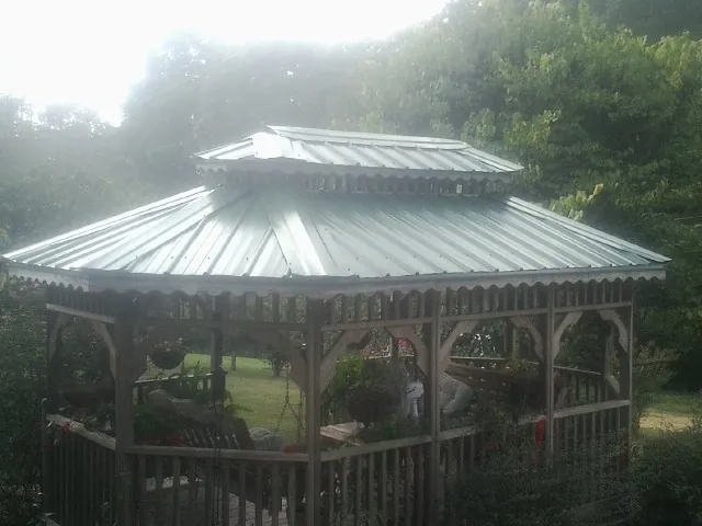 Two tier green metal roof on a garden gazebo in Mc Donald